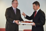 John Vinney presents Zoran Stavreski with a Poole Pottery plate as a memento of the Deputy Prime Minister's visit
